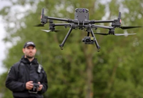 drone pilot jobs - a person flying drone at his job as drone pilot