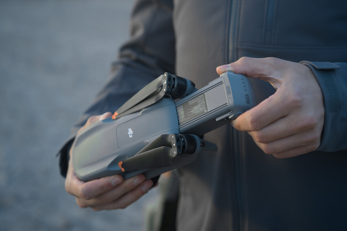 a person holding a drone battery after charging it and flying for the long time